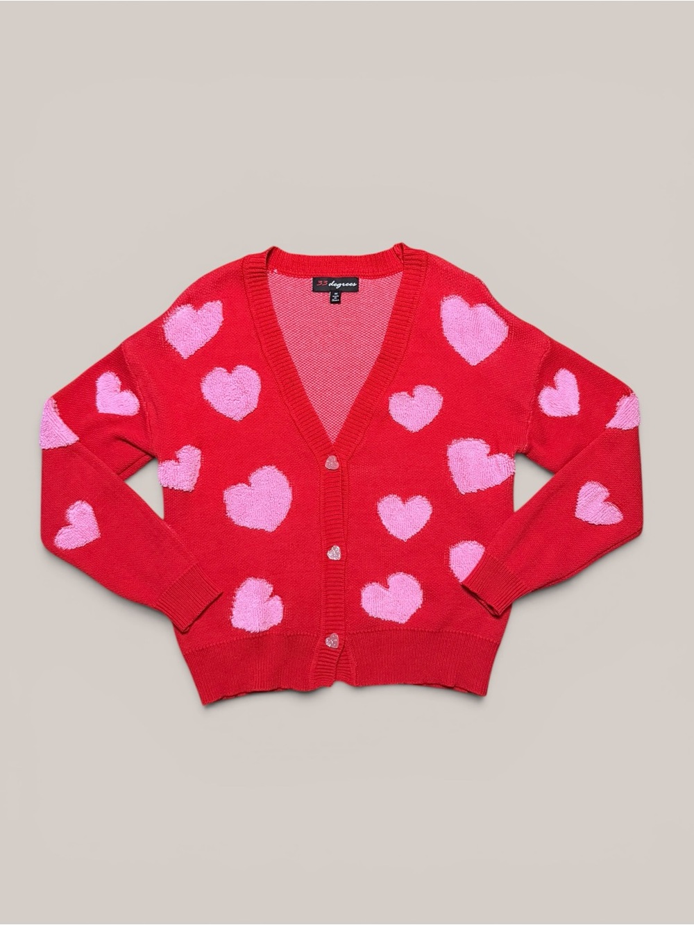 Red cardigan with pink stitched hearts